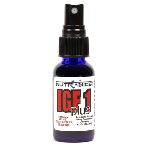 A blue glass spray bottle contains a dietary supplement labeled IGF1 plus. The label features bold black and red text with the brand name Nutronics and a description of the product as an "All Natural Velvet Deer Antler" supplement with a dosage of 25,000 NG. The bottle is topped with a black spray nozzle.